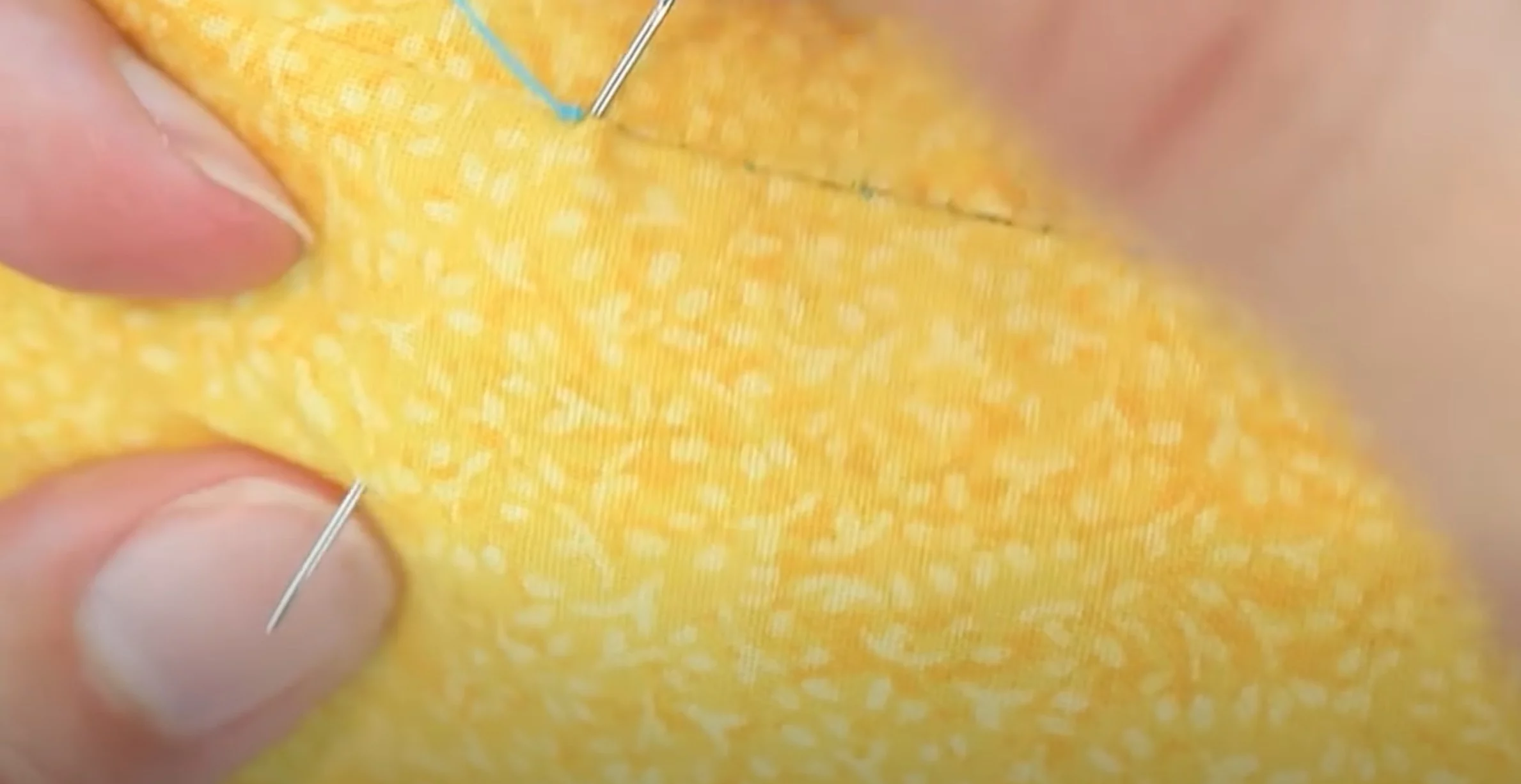 hide the knot by threading the needle into the seam and out the side of the fabric